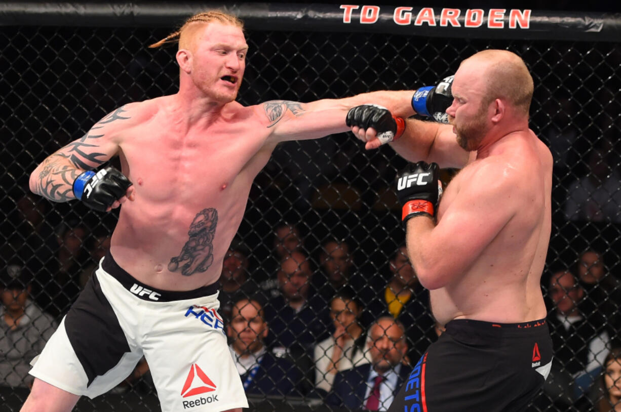 Ed Herman, left, of Battle Ground, punches Tim Boetsch in their light heavyweight UFC bout in January in Boston.