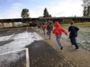 Students run on their way back to class after lunch at Glenwood Heights Primary School in 2010. Glenwood Heights is one of the schools that would be replaced if the $80 million bond is passed in November.