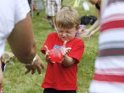 Mason Weyland, 4 of Vancouver participates in the water balloon toss at the 4th of July celebration at Fort Vancouver.