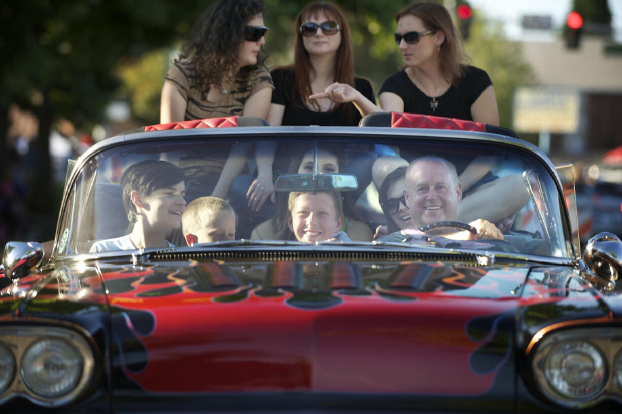 In the front seat from left to right, Andrew Scott, 11, Andrew Allen, 8, Garret Cochran, 12, and driver Terry Krebser take a group of people for a ride in a 1958 Chevy Impala during Cruisin&#039; the Gut in 2013 in Vancouver.