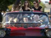 In the front seat from left to right, Andrew Scott, 11, Andrew Allen, 8, Garret Cochran, 12, and driver Terry Krebser take a group of people for a ride in a 1958 Chevy Impala during Cruisin&#039; the Gut in 2013 in Vancouver.