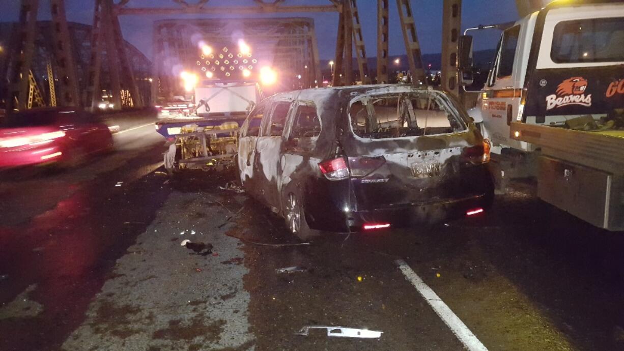 At about 3:25 a.m., a car drove into a work zone and crashed into a truck, according to the Oregon Department of Transportation. The driver of the car got out and ran south on the bridge, leaving behind a woman and small child. The car caught fire and an ODOT contractor broke a window to help the woman and child get out before the car was consumed by flames, traffic officials said.