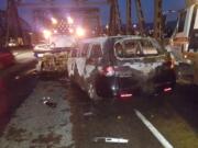 At about 3:25 a.m., a car drove into a work zone and crashed into a truck, according to the Oregon Department of Transportation. The driver of the car got out and ran south on the bridge, leaving behind a woman and small child. The car caught fire and an ODOT contractor broke a window to help the woman and child get out before the car was consumed by flames, traffic officials said.