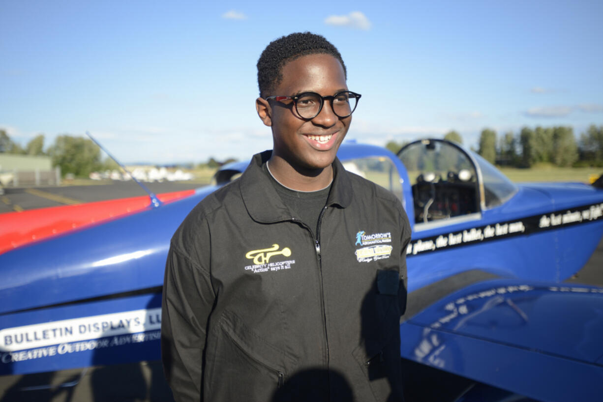 Pilot Isaiah Cooper, 16, talks with members of the media Tuesday after landing at Pearson Field in Vancouver. It was the first leg of a planned journey around the continental U.S.