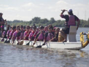 The Pink Phoenix dragon boat team, all breast cancer survivors, paddle at Vancouver Lake Sunday in Row for the Cure, a fundraiser for breast cancer research sponsored by the nonprofit group Susan G. Komen of Oregon and SW Washington.