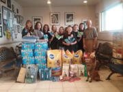 Hazel Dell: Diamond in the Ruff 4-H dog club donated pet food and other items to the Hazel Dell Animal Hospital. From left: Bobbe Whetsell, Megan Whetsell, Jessi Davidson, Rebekah Elvestrom, McKenna Miltenberger, Madison Davidson, Alyssa Selfridge, Kathy Berg, Dr.