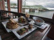 A smoked brisket sandwich, clockwise from left, rough cut chuck burger, knife-and-fork chowder and seared-slab bacon are part of the WareHouse&#039;s culinary inventory.