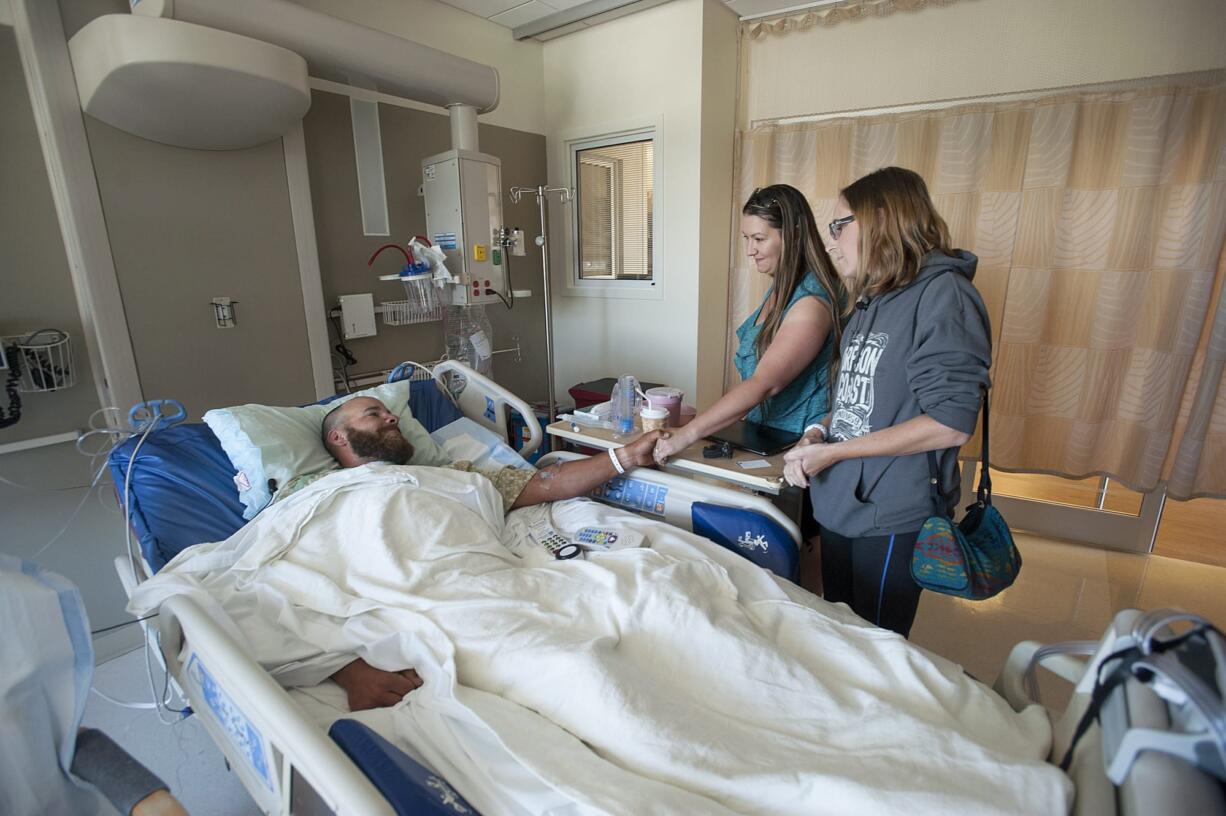 Scott Jensen of Amboy, from left, thanks rescuers Hiedi Poulson of Brush Prairie and Kim Detter of Battle Ground during their visit Wednesday morning, July 6, 2016 at PeaceHealth Southwest Medical Center.