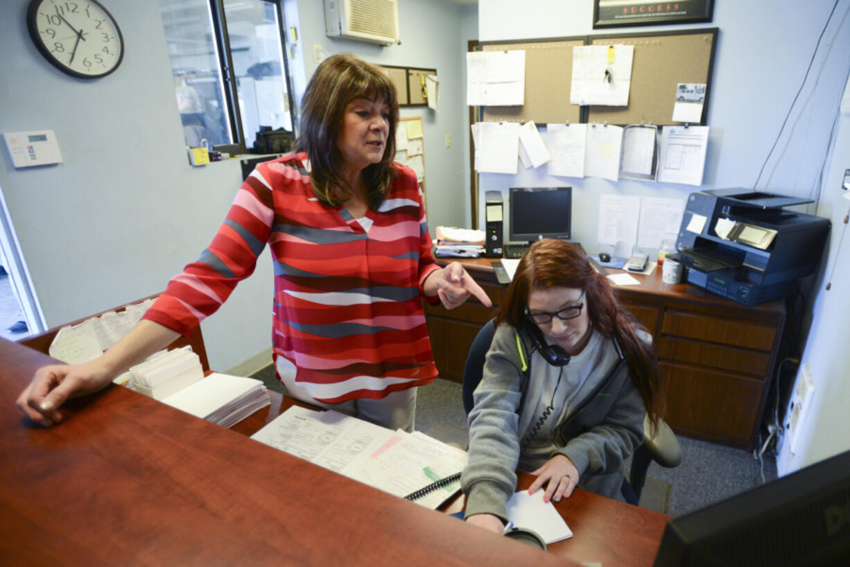 Darlene Scherer-O&#039;Mara, left, a dispatcher at Chappelle&#039;s Towing LLC in Vancouver, trains Chelsea Bonawitz on Wednesday.