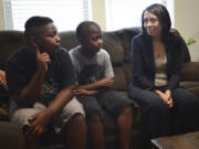 Keyonne Hill, 10, left, and Horace Hill, 9, speak with U.S. Senator Maria Cantwell about living at Lilac Place Apartments in Woodland. Cantwell visited Lilac Place on Friday to speak with Cowlitz County affordable housing agencies and local officials about the need for more affordable housing in the region.