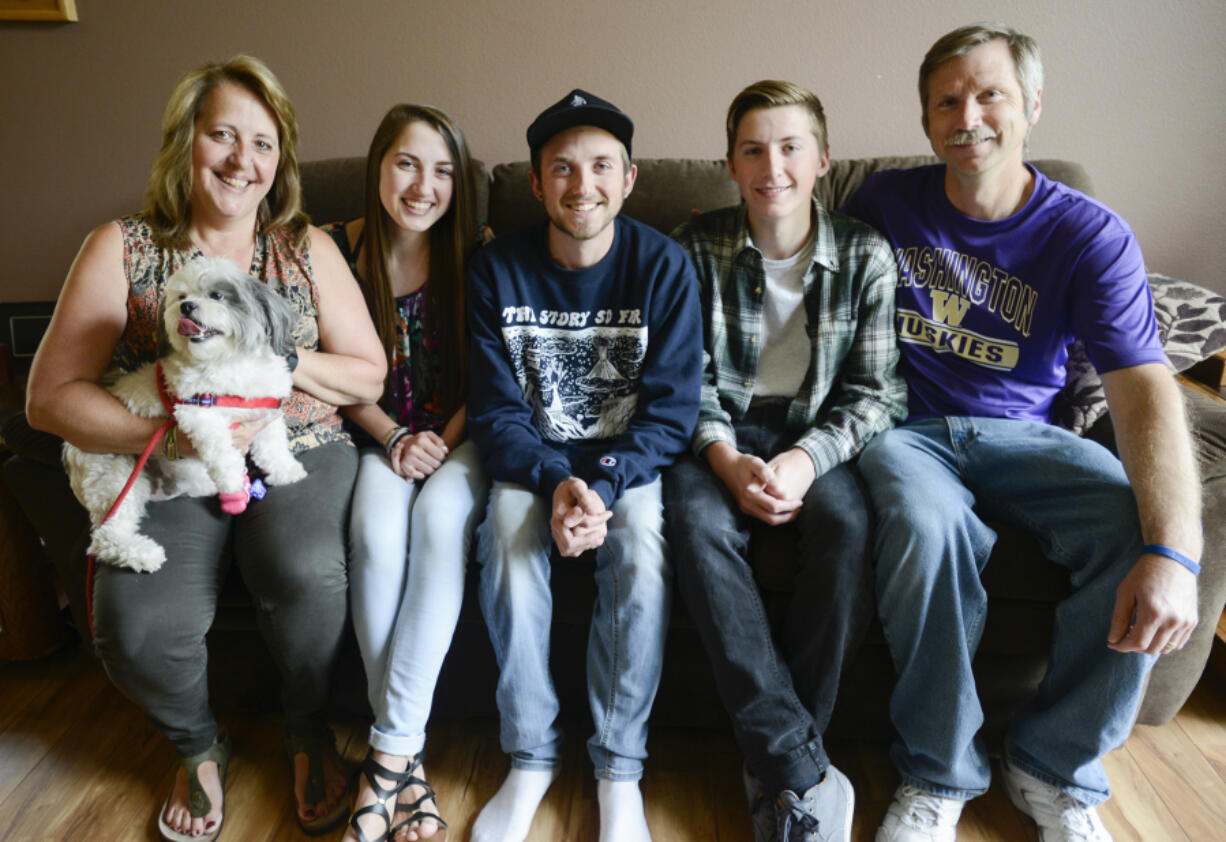 Mary, from left, McKenna, Matt, Adam and Steve Pozsgai, sit together in their Salmon Creek home. Matt, 21, has cystic fibrosis and struggles daily to maintain his health. His sister, McKenna, 16, recently was selected by Cystic Fibrosis Foundation to advocate to lawmakers in Washington, D.C., about improving research and funding for cystic fibrosis.