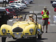 Bill and Mary Jane Peden of Hockinson arrive in their 1951 Allard K-2 at the 2014 Camas Car Show.