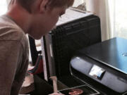 Esther Short: A student in Raymond Klein&#039;s July 13 photography class checks out his work.