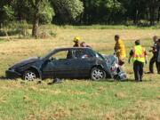 Police and firefighters respond Thursday afternoon at the Ridgefield Wildlife Refuge after an end-over-end rollover crash that left at least one occupant of this car with serious injuries.