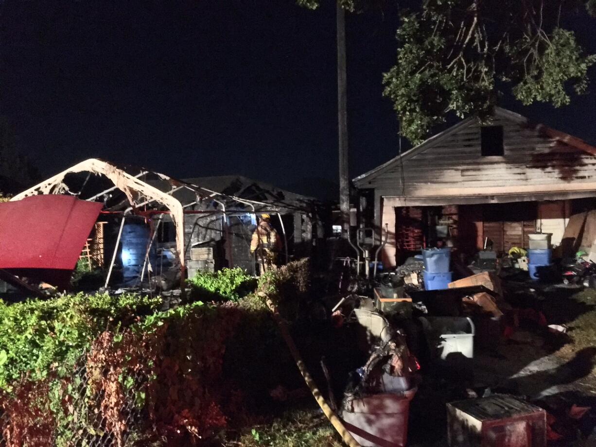 A fire spread from a detached shop to a detached garage in Woodland early Thursday morning, damaging a power pole and displacing several people.