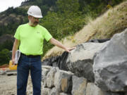 Landscape architect and rock-project manager Kelly Punteney of Colf Construction describes what he digs and doesn&#039;t dig in slabs of basalt. Punteney, a Vancouver resident and former parks and recreation official here, has been helping to build a new 1.32-mile segment of the Historic Columbia River Highway and State Trail near Hood River, Ore.