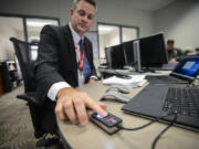 A scanner recognizes the fingerprint of Justin Davis. Davis&#039; company, Executive Information Systems, sold the county the new biometric technology being implemented at the Clark County Jail.