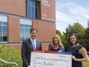 Central Park: David Reiter, senior vice president and private client manager for Bank of America, left; and Jessica Hewitt, vice president of enterprise business and community engagement for Bank of America, right, present Judy Starr, director of corporate and foundation relations at the Clark College Foundation, with $20,000 grant for a student financial coach at Clark College in Vancouver.