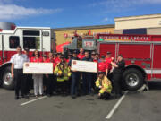 Brush Prairie: Members of Fire District 3 with Riverside Fire and Rescue and representatives from Firehouse Subs Public Safety Foundation, which donated a heart monitor and defibrillator to District 3.