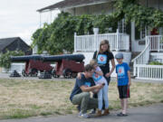 Tim Fry, from left, shows daughter Ruby, wife Kristine and son Henry information about Fort Vancouver on his smartphone app. The family from Lopez Island is touring state historical sites after Tim Fry helped eighth-grade students develop the app.