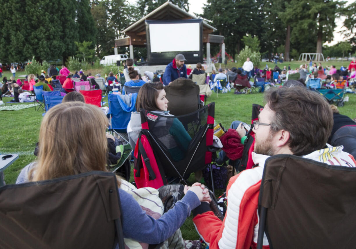 Robin Schwartz, left, and Nathan Klavano hold hands just before the showing of &quot;Star Wars: The Force Awakens&quot; in Marshall Park in Vancouver on a recent Friday night.