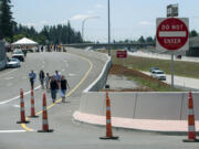 Participants in the Wednesday morning ribbon-cutting event walk down the new I-205 northbound offramp to Northeast 18th Street following the ceremony, and before the road opened to traffic for the afternoon commute.