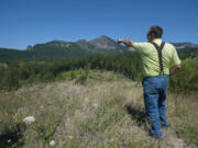 Ted Salka explains where his property meets with land owned by the U.S. Forest Service in Skamania County. Salka is in the process of selling some land to the agency, but has been met by opposition by local officials.