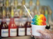 A shaved ice with cherry, banana and blue raspberry flavors is displayed at Megan&#039;s Snack Shack.