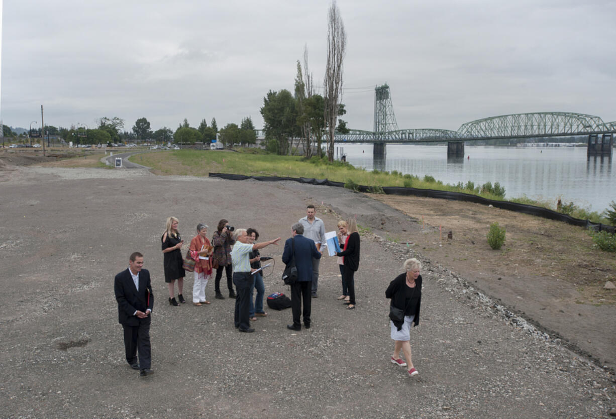 Barry Cain of Gramor Development, center in green shirt, points out where work will be done at the new Vancouver Waterfront project.