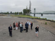 Barry Cain of Gramor Development, center in green shirt, points out where work will be done at the new Vancouver Waterfront project.