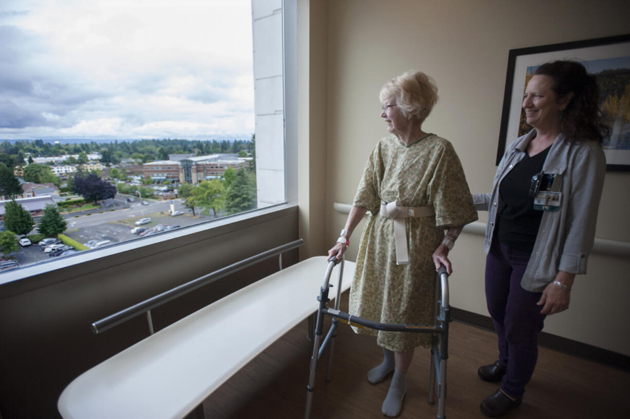 Betty Shrum of Vancouver, left, and physical therapist Brenda Powell check out the sixth-floor view Friday morning during a walk around the Thomas and Sandra Young Neurosciences Center at PeaceHealth Southwest Medical Center.