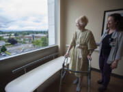 Betty Shrum of Vancouver, left, and physical therapist Brenda Powell check out the sixth-floor view Friday morning during a walk around the Thomas and Sandra Young Neurosciences Center at PeaceHealth Southwest Medical Center.