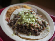 Two carne asada tacos are served with rice and beans Thursday morning, July 7, 2016 at Javier&#039;s Tacos.