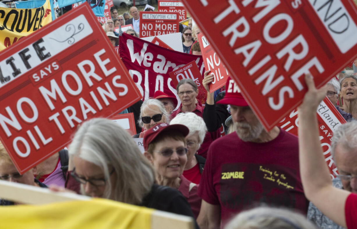 Oil terminal protesters march with signs and chant slogans in downtown Vancouver ahead of Monday night&#039;s city council meeting.