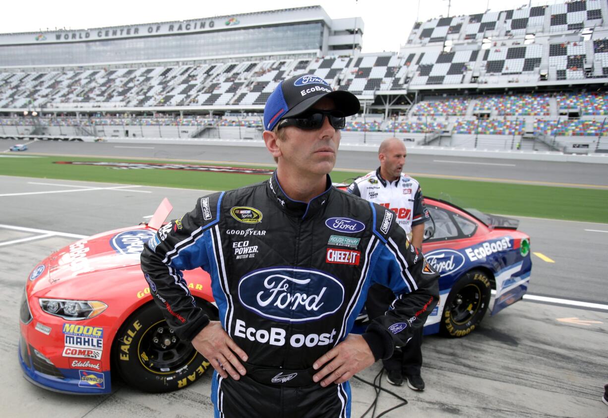 Greg Biffle looks up at the scoring monitor after he qualified for Saturday night's NASCAR Sprint Cup auto race at Daytona International Speedway, Friday, July 1, 2016, in Daytona Beach, Fla.