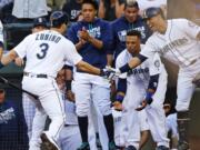 Seattle Mariners' Mike Zunino (3) is greeted at the dugout by teammates after he hit a two-run home run against the Baltimore Orioles during the second inning of a baseball game, Saturday, July 2, 2016, in Seattle. (AP Photo/Ted S.