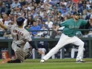 Houston Astros' Carlos Correa slides into home to score on a wild pitch by Seattle Mariners starting pitcher James Paxton, right, during the fifth inning of a baseball game Friday, July 15, 2016, in Seattle. (AP Photo/Ted S.