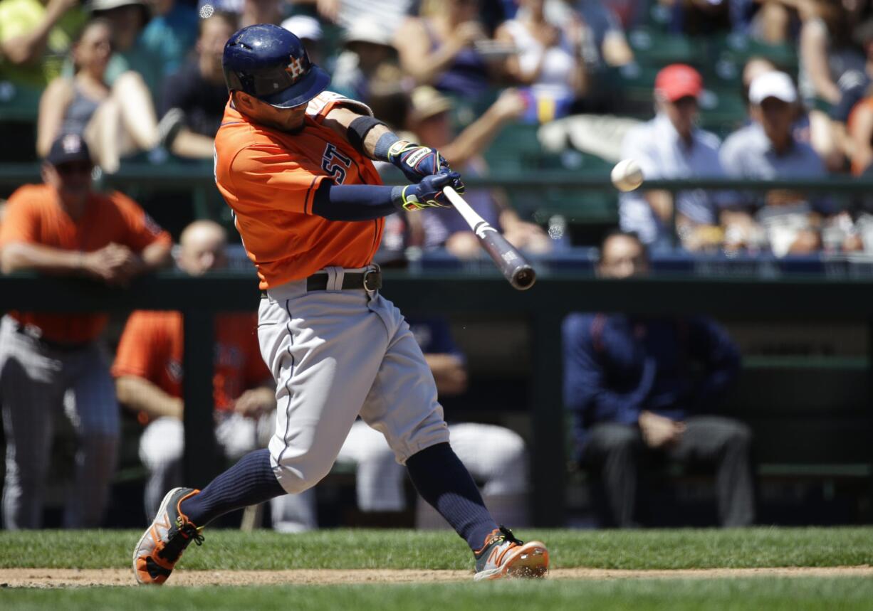 Houston Astros' Jose Altuve hits a two-run home run in the third inning of a baseball game against the Seattle Mariners, Sunday, July 17, 2016, in Seattle. Astros' Marwin Gonzalez also scored on the play. (AP Photo/Ted S.