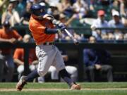 Houston Astros' Jose Altuve hits a two-run home run in the third inning of a baseball game against the Seattle Mariners, Sunday, July 17, 2016, in Seattle. Astros' Marwin Gonzalez also scored on the play. (AP Photo/Ted S.