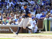 Seattle Mariners' Leonys Martin (12) crosses home plate as he scores on a wild pitch thrown by Chicago Cubs relief pitcher Aroldis Chapman (54) during the eighth inning of an interleague baseball game, Saturday, July 30, 2016, in Chicago.