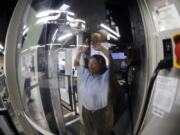 A Transportation Security Administration officer candidate passes through a body scanner as she plays the part of an air traveler during a training session in an airport security checkpoint simulator at the Federal Law Enforcement Training Center in Brunswick, Ga. Short-staffed and often criticized, the TSA aims to improve training for airport screeners.