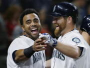 Seattle Mariners&#039; Nelson Cruz, left, reacts as he greets Mariners&#039; Adam Lind, right, after Lind hit a solo home run against the Orioles. (Ted S.