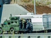 SWAT team members use an armored vehicle while investigating a stolen RV on northbound Interstate 205 on July 30. The investigation led to a 2.5-hour freeway closure.