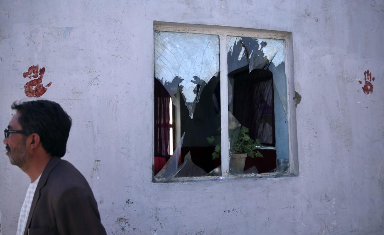 A wall is marked with hand prints in blood after a deadly explosion struck a protest march by ethnic Hazaras, in Kabul, Afghanistan, Saturday, July 23, 2016. Afghan Health Ministry officials say tens of people have been killed and over 200 wounded in the bombing Saturday, that was claimed by the Islamic State group according to a statement posted on the IS-linked Aamaq online news agency. The protesters Saturday were demanding that a major regional electric power line be routed through their impoverished home province.