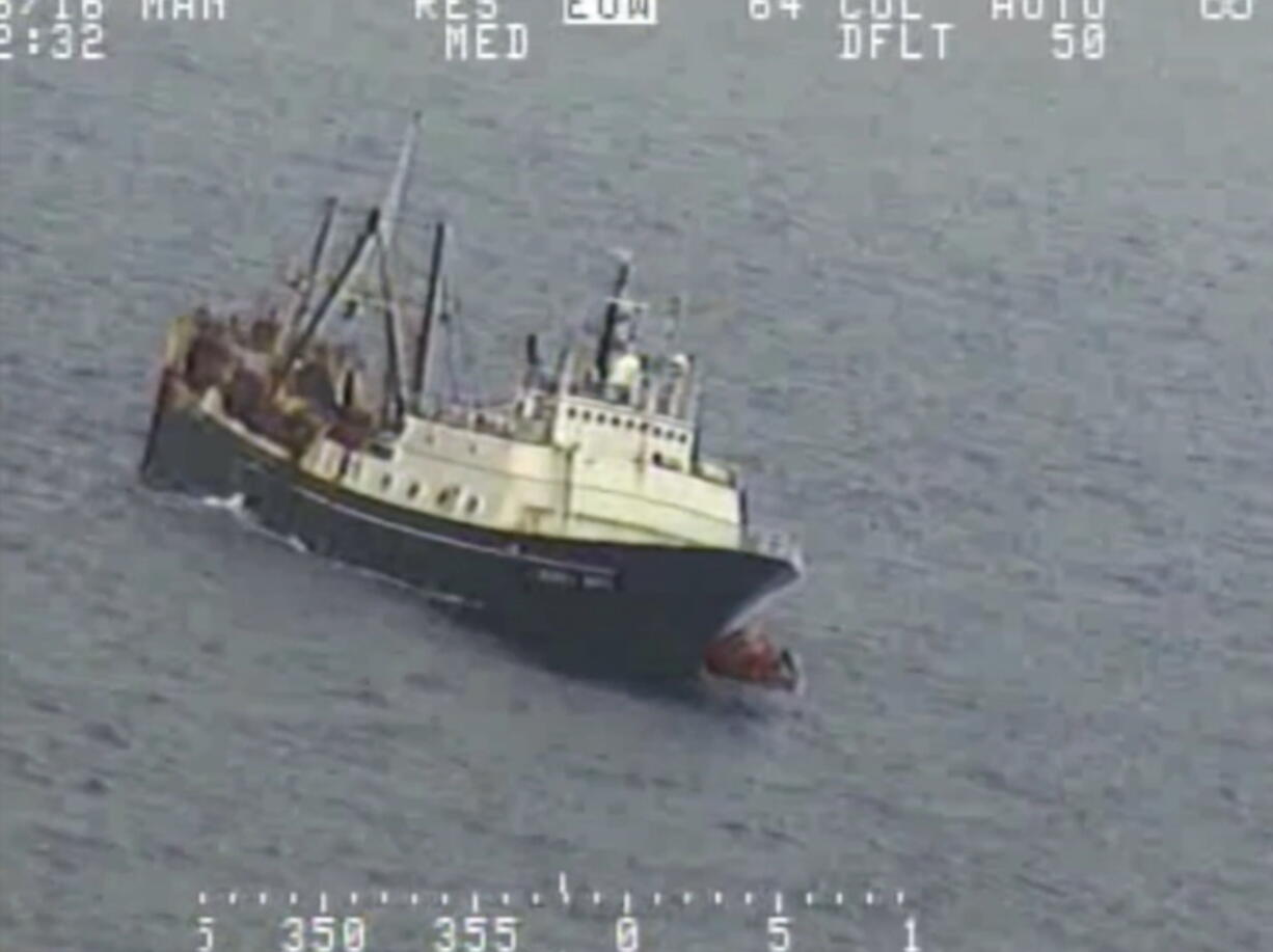 Crew from a sinking fishing boat, left, board life rafts off Alaska&#039;s Aleutian Islands in the Bering Sea. When the Alaska Juris started taking on water Tuesday, crew members donned survival suits and got into rafts. (U.S.