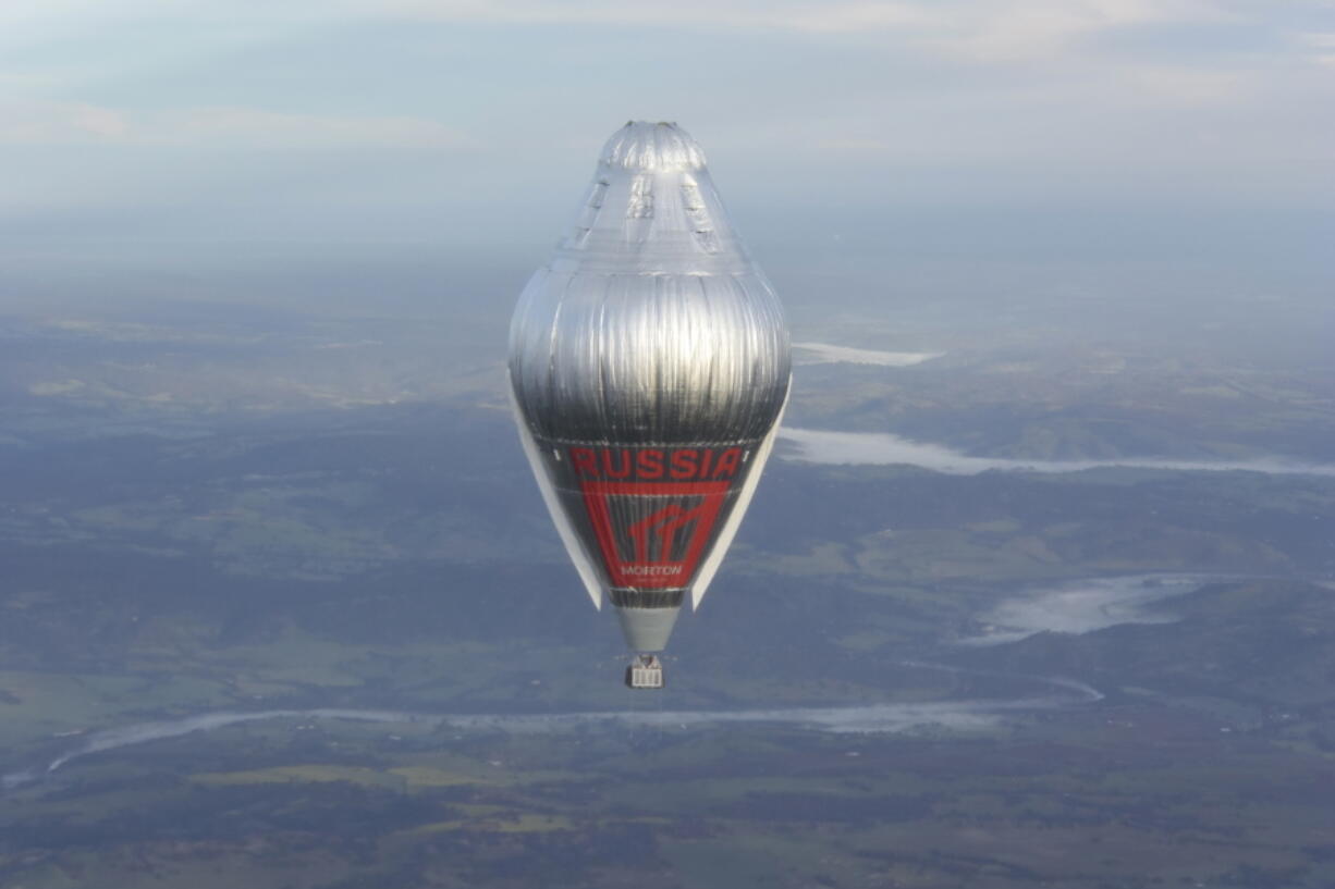 Russian adventurer Fedor Konyukhov floats at more than 6,000 meters (20,000 feet) above an area close to Northam in Western Australia state in his helium and hot-air balloon as he makes a record attempt to fly solo in a balloon around the world nonstop. Konyukhov, 65, was battling sleep deprivation, freezing temperatures and ice in his oxygen mask as he nears the end of his record attempt to fly solo around the world nonstop, his son said on Wednesday July 20, 2016.