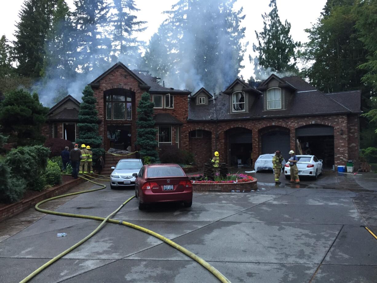 Fire badly damaged a 7,444-square-foot house just south of Battle Ground.