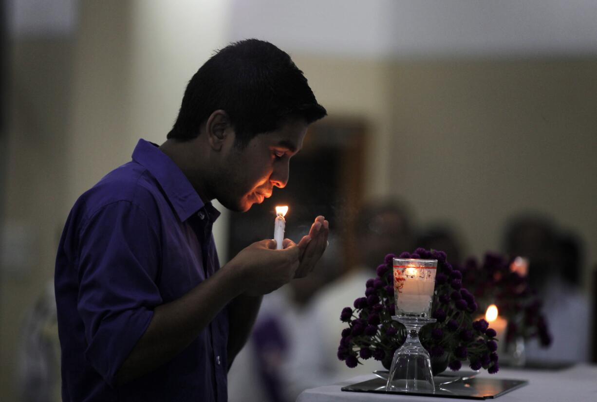 A Bangladeshi boy lights a candle as people attend a mass in memory of the victims of the attack on Holey Artisan Bakery, led by papal envoy in Bangladesh, Monsignor George Kocherry, in Dhaka, Bangladesh, Monday, July 4, 2016. The brutality of the attack, the worst convulsion of violence yet in the recent series of deadly attacks to hit Bangladesh, has stunned the traditionally moderate Muslim nation and raised global concerns about whether it can cope with the increasingly strident Islamist militants.