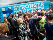 Democratic presidential candidate Hillary Clinton takes a photo with a man outside Grandma&#039;s Cheese Barn in Ashland, Ohio, Sunday. Clinton and running mate Tim Kaine are on a three day bus tour through the rust belt.