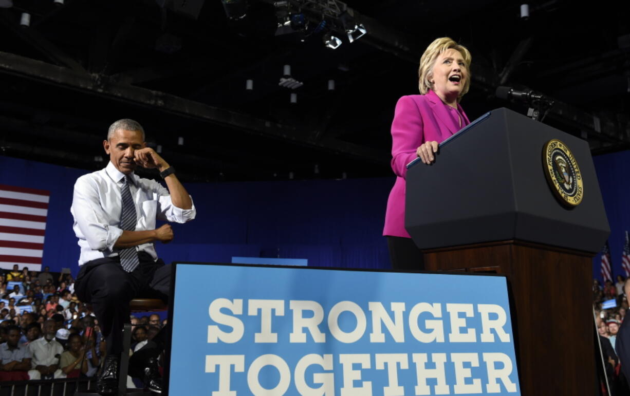 President Barack Obama pretends to wipe away tears as Democratic presidential candidate Hillary Clinton talks about Malia Obama graduating college, Tuesday, July 5, 2016, during a campaign event at the Charlotte Convention Center in Charlotte, N.C. Obama is spending the afternoon campaigning for Clinton.